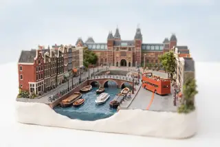 Miniature model of Amsterdam with an orange sightseeing bus