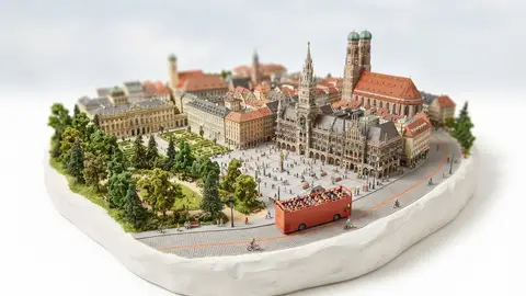 Miniature model of Munich with an orange sightseeing bus
