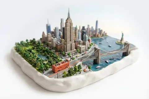 Miniature model of New York with an orange sightseeing bus