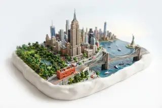 Miniature model of New York with an orange sightseeing bus